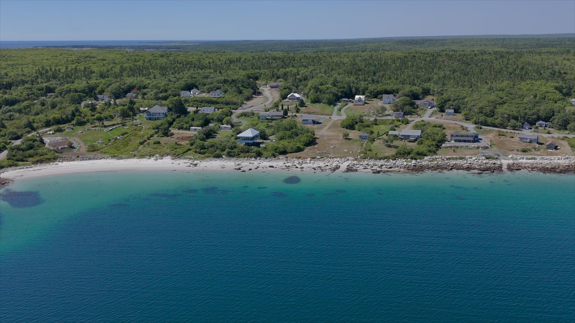 White-sand beach and clear Atlantic water in Port Mouton, Nova Scotia