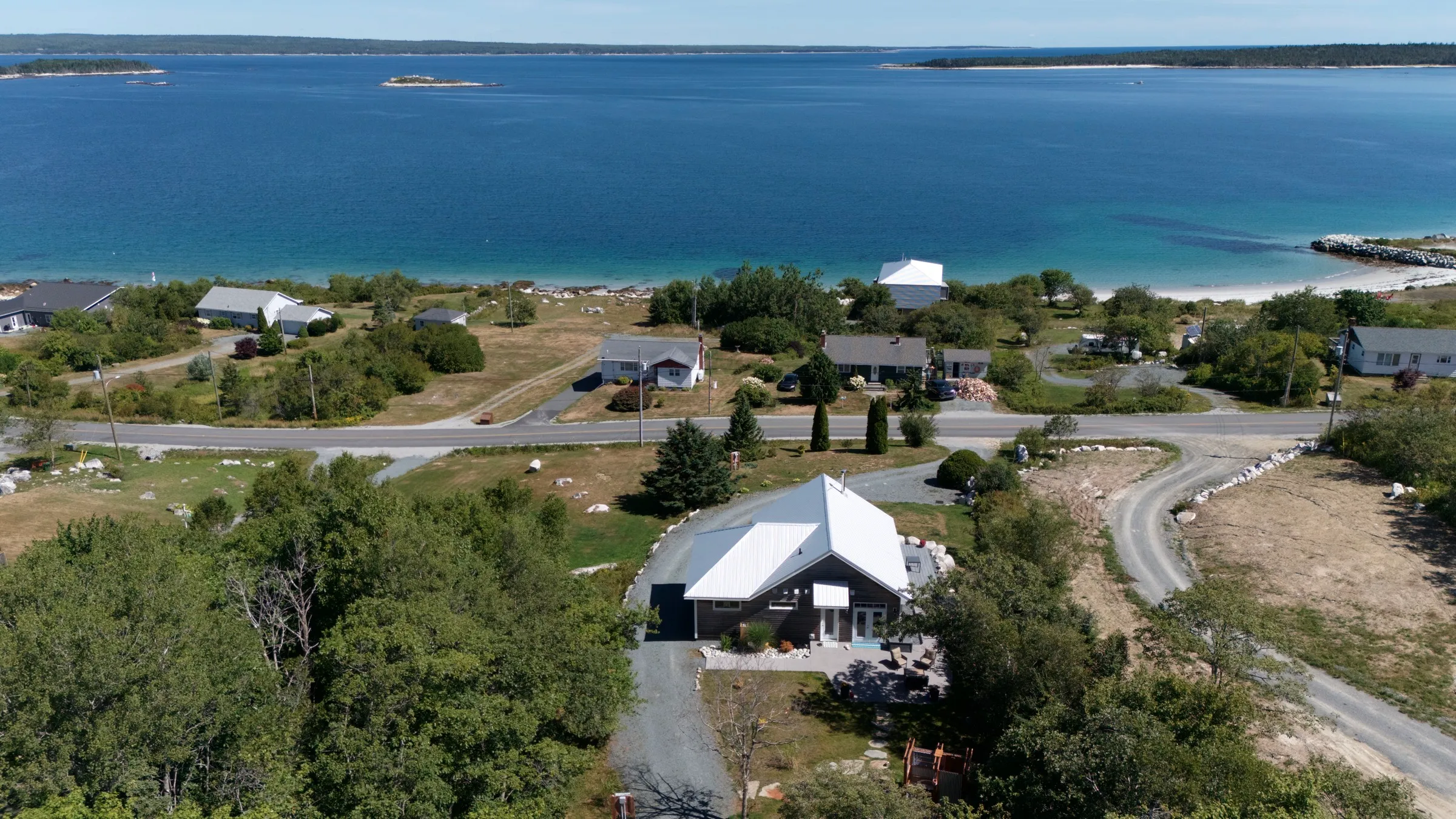 Aerial view of Hi Tides above the white-sand beach and bay in Port Mouton, Nova Scotia