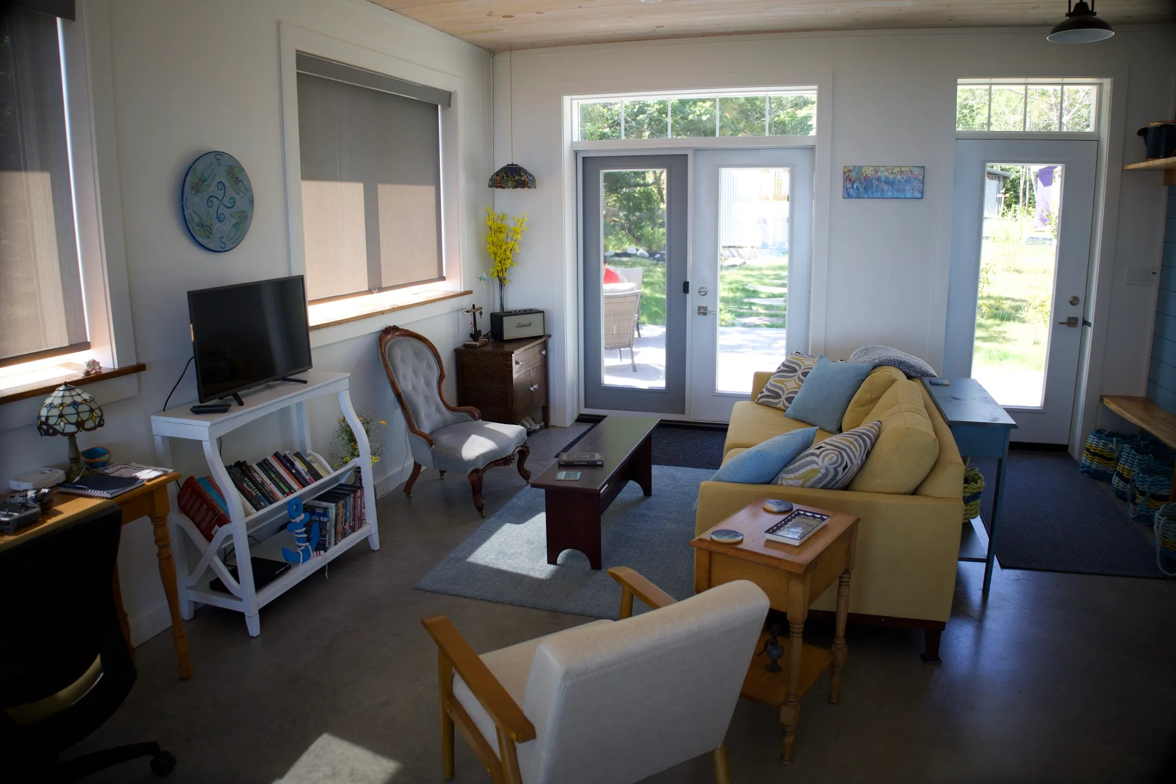 Bright living area with a mustard sofa and coastal daylight